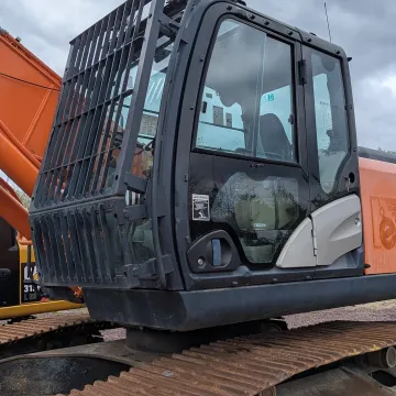 Fleet of construction equipment including earthmoving machines and skid steers at Rossini Equipment yard
