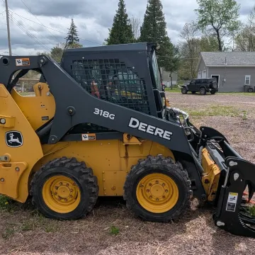 Well-maintained track loader with hydraulic attachment working on a construction site