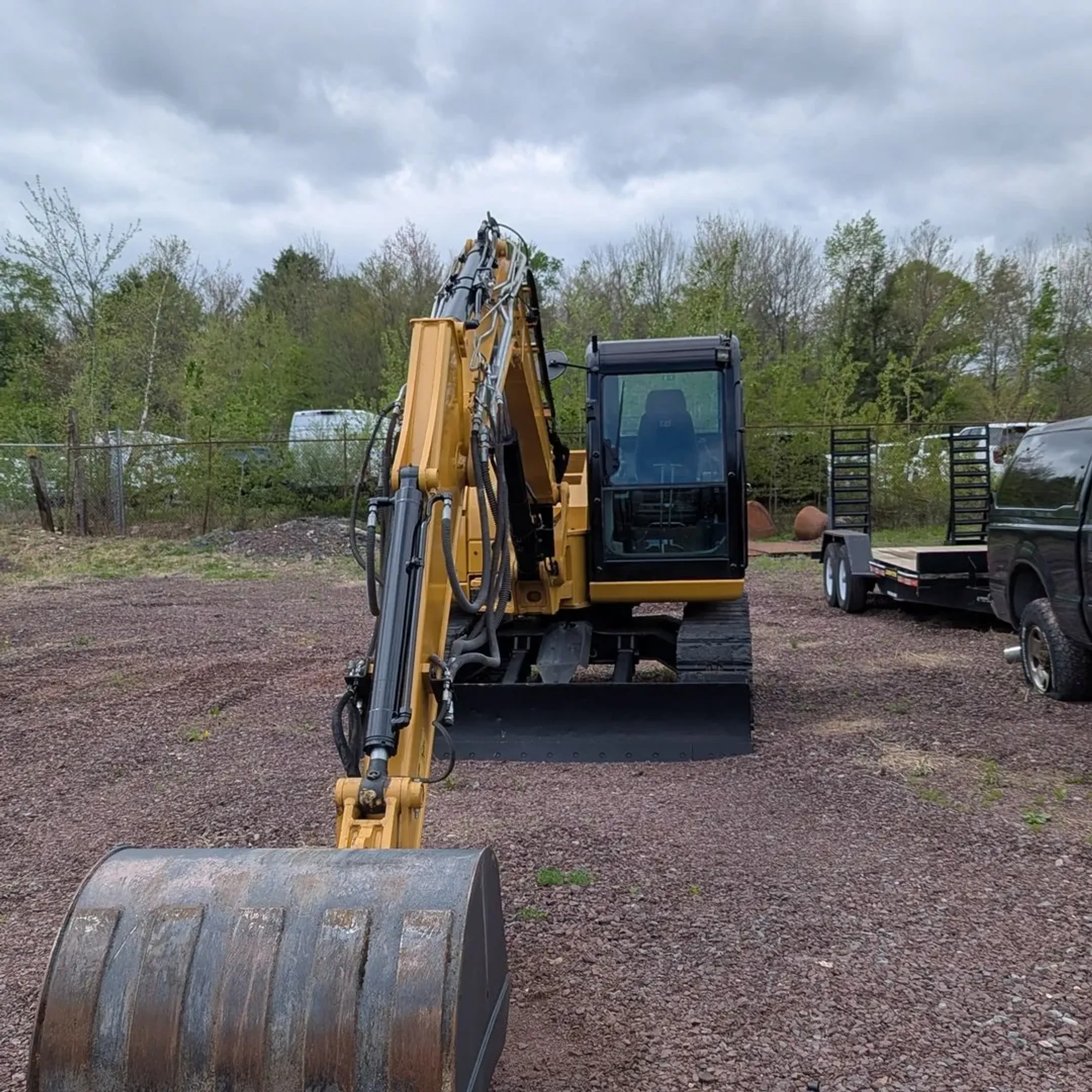 Modern earthmoving machine and skid steer equipment ready for rental at jobsite