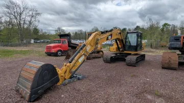 Rossini Equipment Corp yard showing equipment fleet and transport trucks