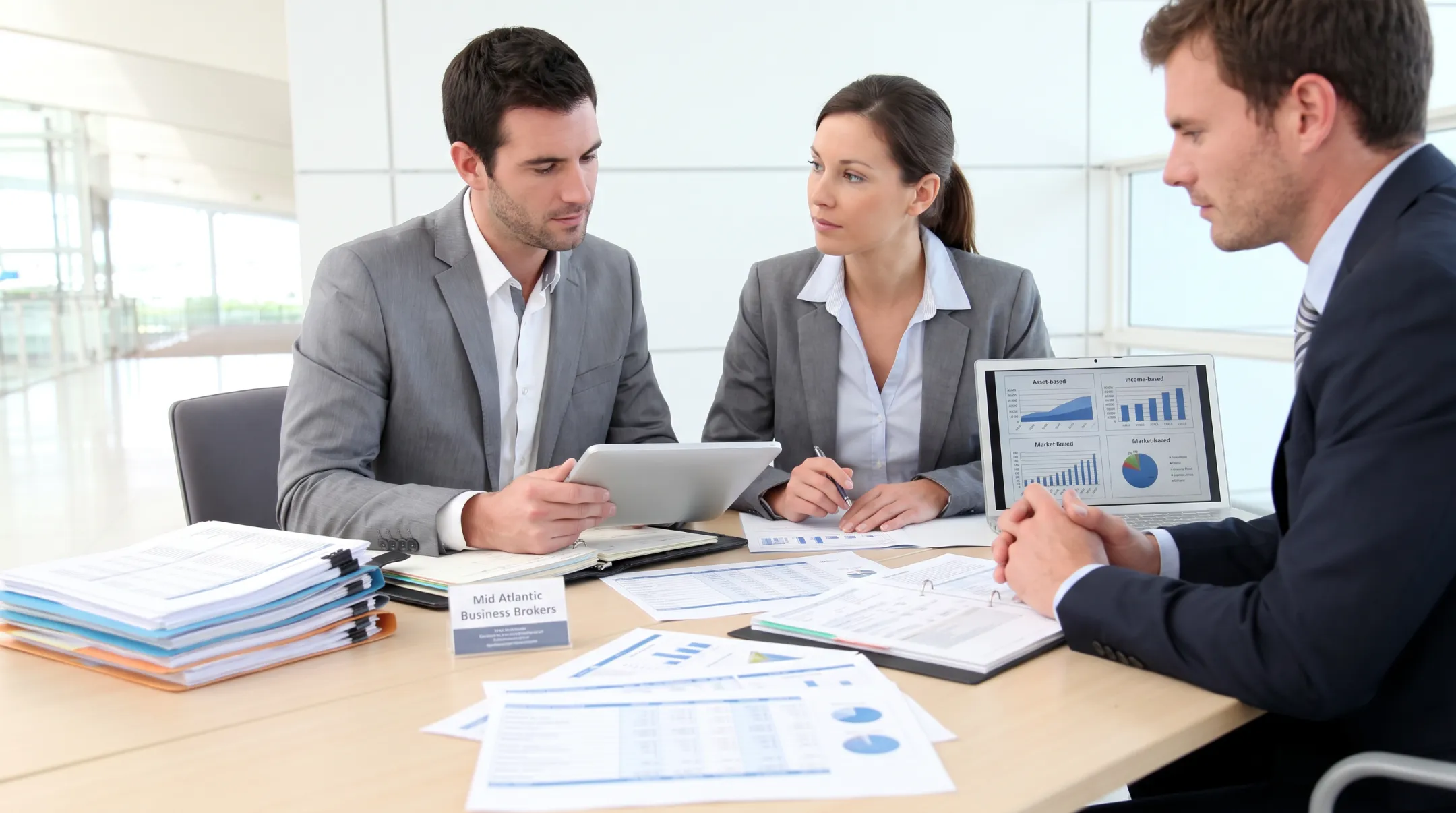 Business brokers reviewing retail valuation documents and financial records