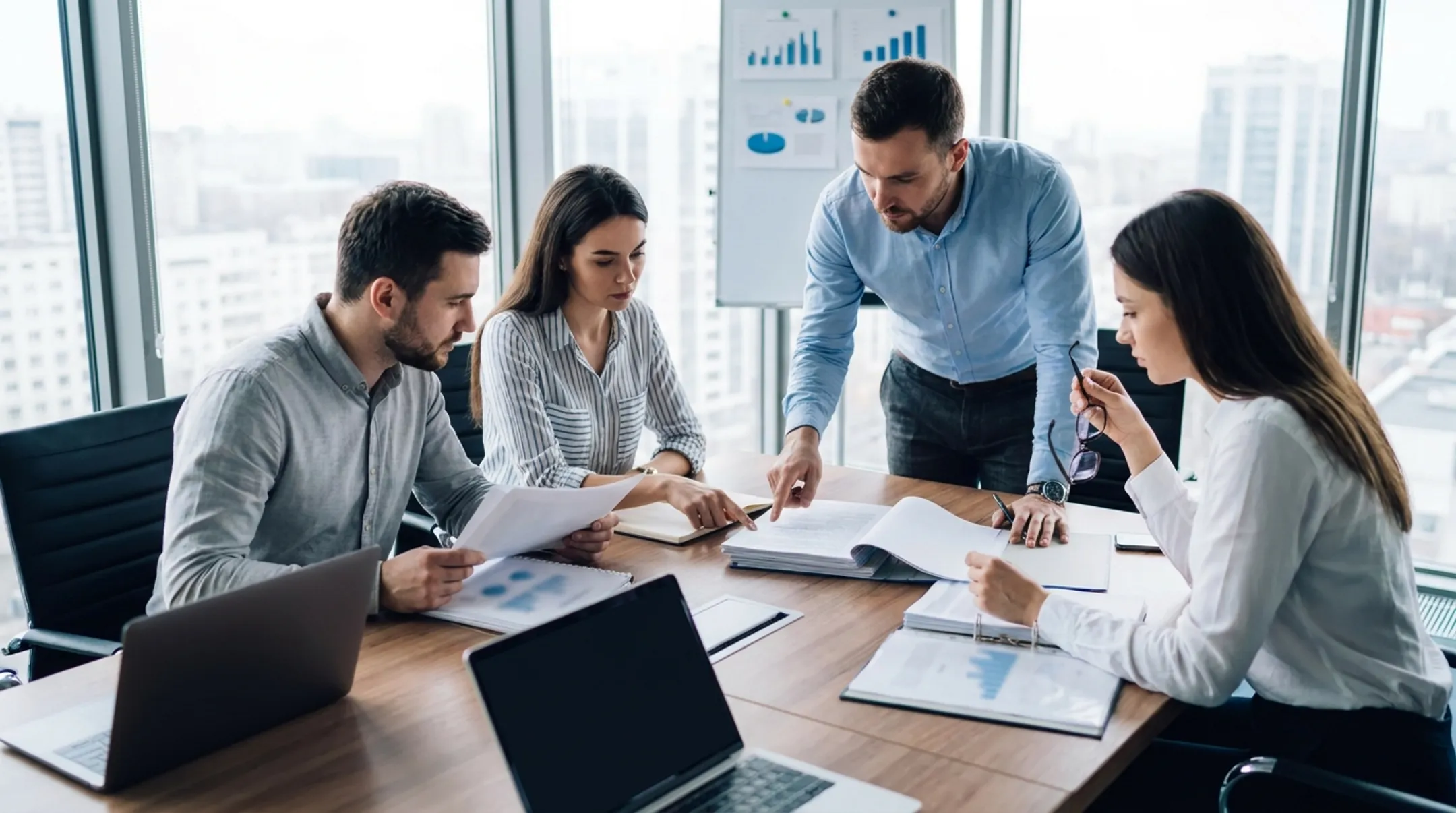 Business valuation advisors reviewing confidential financial documents together