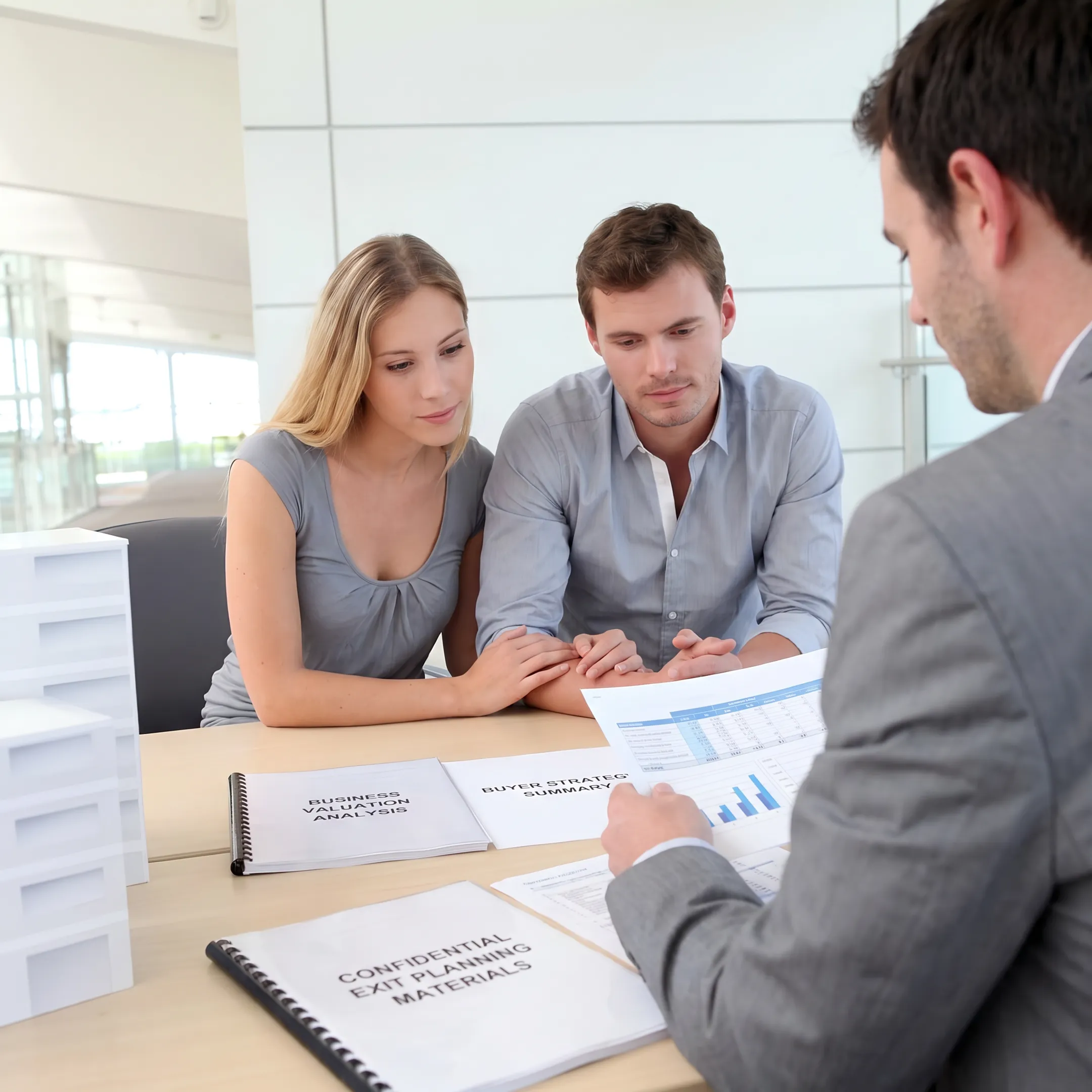 Advisor presenting a business valuation and sale strategy to an owner