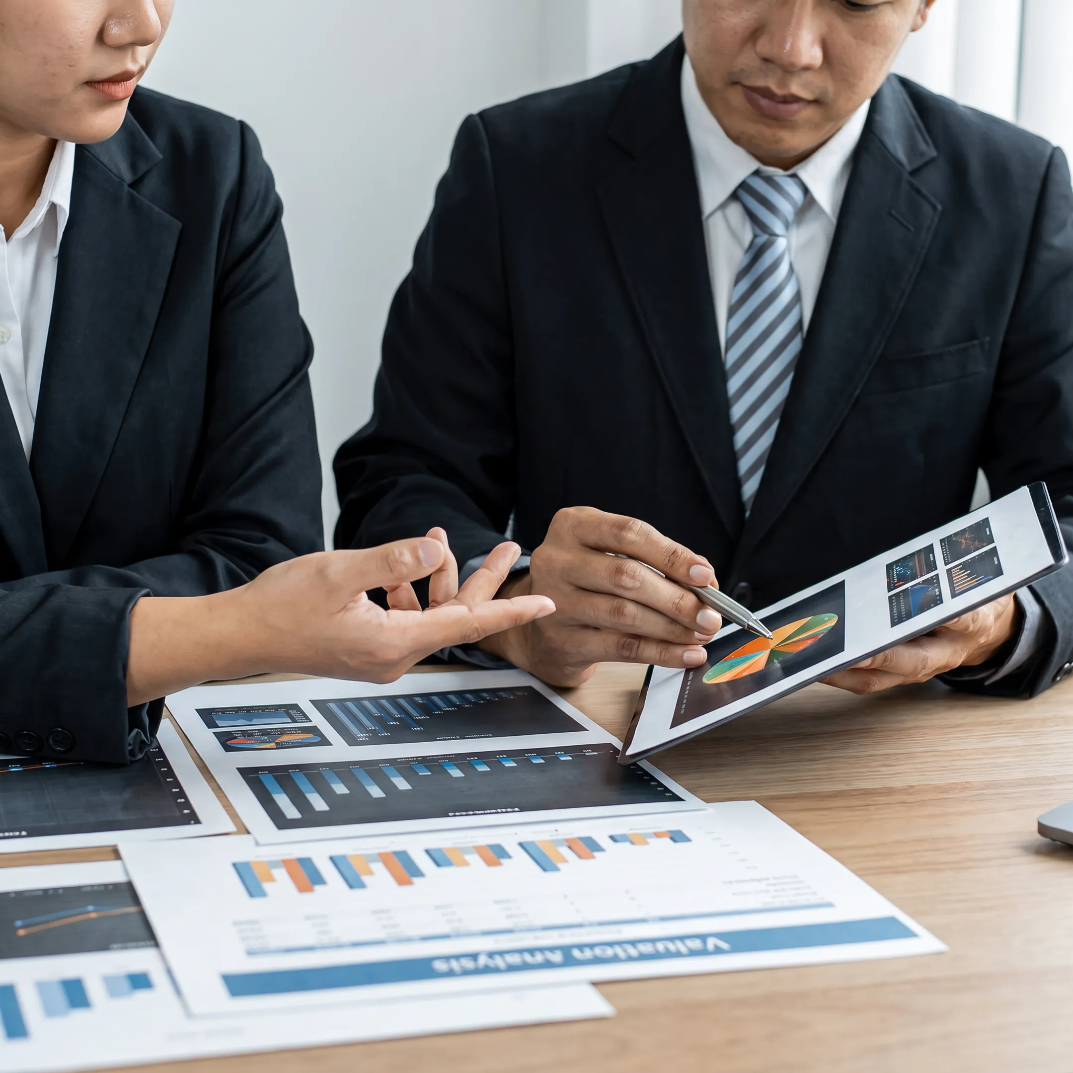 Business advisor presenting a valuation analysis to a business owner