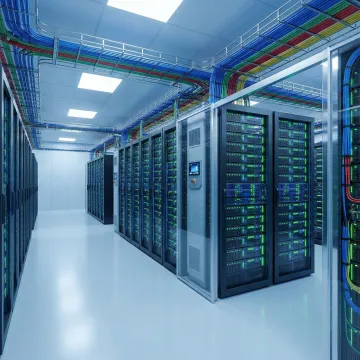Modern data center server racks with blue LED indicators and structured cabling in a secure colocation facility