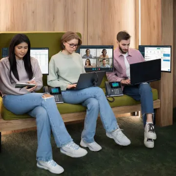 Modern office workspace with cloud-based VoIP phone system and video conferencing setup