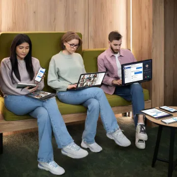 Business team collaborating using unified communications tools across multiple devices