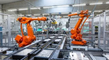 Industrial robot arm performing precision assembly on modern manufacturing production line