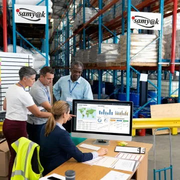 Team collaborating on logistics software dashboard