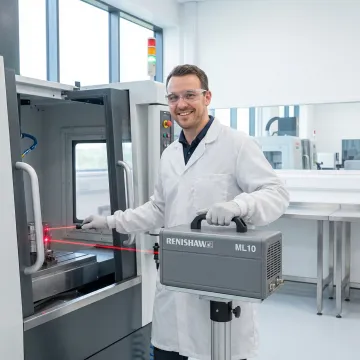 Calibration technician conducting precision measurement on CNC machine tool