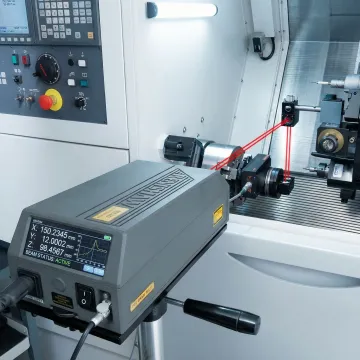Precision laser interferometer calibrating CNC machine axis in Washington manufacturing facility