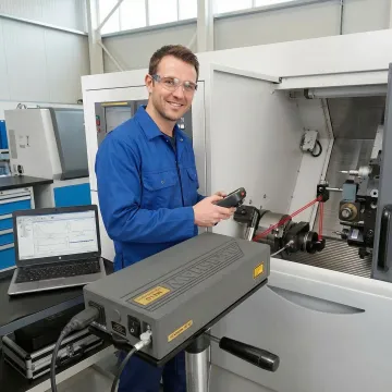 Precision CNC machine undergoing backlash testing with digital measurement equipment