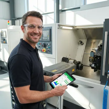 Calibration technician analyzing precision measurement data on industrial equipment