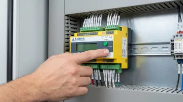 Electronics manufacturing facility technician performing system-level box build inspection