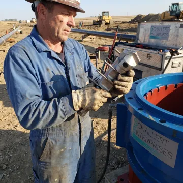 Technician inspecting carbide pipeline cutter