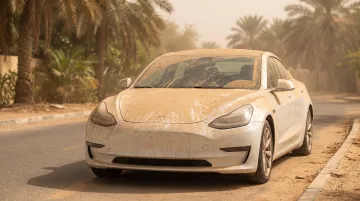 Dust and sand particles settling on car hood in desert climate