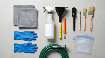 Engine cleaning tools degreaser brushes microfibre towels and garden hose laid out