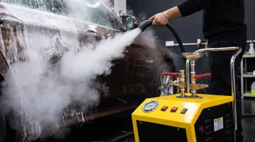 Professional mobile car steam cleaning machine in use on vehicle