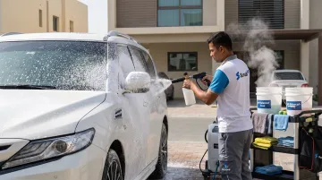 Mobile car wash technician steam cleaning ceramic coated vehicle doorstep