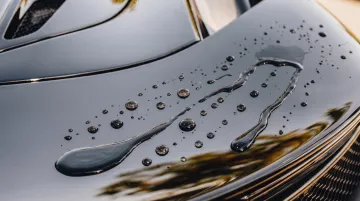 Water beading hydrophobic effect on ceramic coated car surface