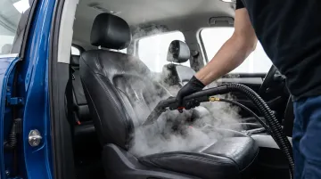 SUV interior seats being professionally steam cleaned by technician