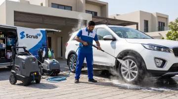 Mobile car wash technician steam cleaning car at doorstep location