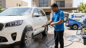ScrubUp mobile wash technician performing steam wash on car wheels