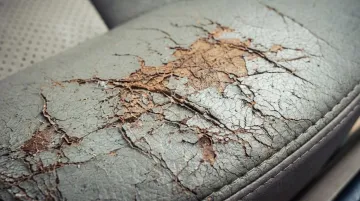 Cracked dried leather car seat showing heat and UV damage requiring professional restoration