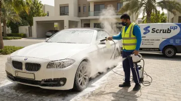 ScrubUp mobile car wash technician hand-washing convertible at doorstep