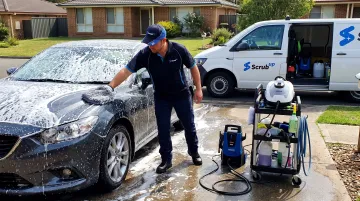 ScrubUp mobile technician hand washing car at villa driveway