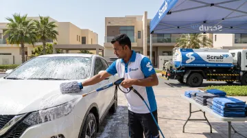 ScrubUp mobile detailing technician washing car at customer doorstep