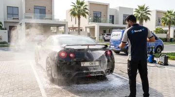 ScrubUp mobile car wash technician pressure washing vehicle at residential parking