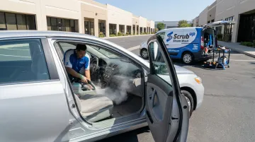 ScrubUp steam wash service treating car interior seats carpets and cabin surfaces