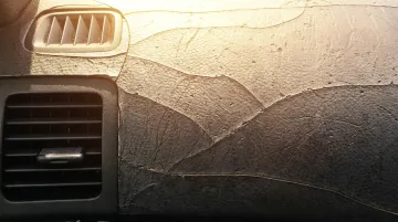 Car dashboard in extreme heat showing sun damage and surface cracking from UV exposure