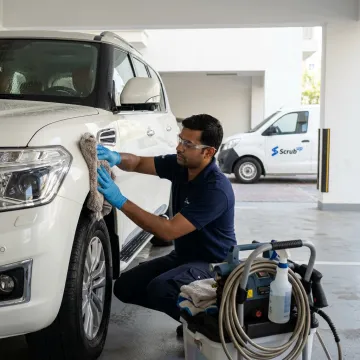 Technician applying ceramic coating to car paint