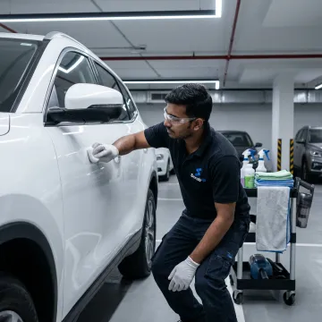 Technician polishing cloudy car headlights