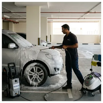 Mobile car wash technician cleaning a car in Dubai