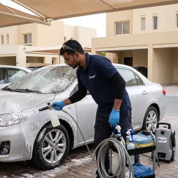 Mobile technician washing a car in Dubai