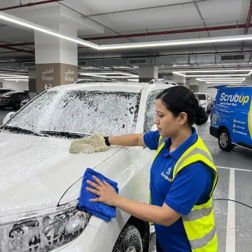 Technician detailing a car exterior