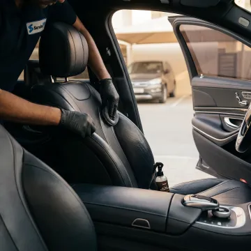 Technician conditioning car leather seat