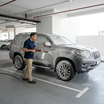 Mobile car wash technician detailing a Toyota Prado