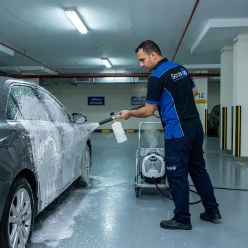 Mobile car wash technician cleaning vehicle