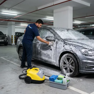 Mobile car wash process in a Dubai parking bay