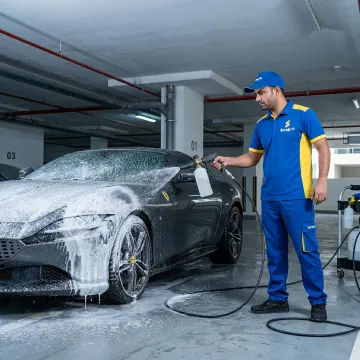 Mobile technician cleaning a sports car