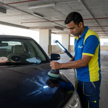 Technician machine polishing a car