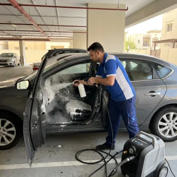 Mobile car wash process at a parked vehicle