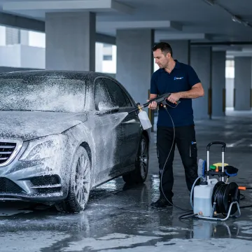Mobile car wash service cleaning a luxury car in Dubai