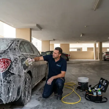 Mobile car wash service in Dubai parking area