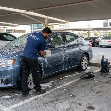 Mobile car wash in Motor City Dubai parking bay