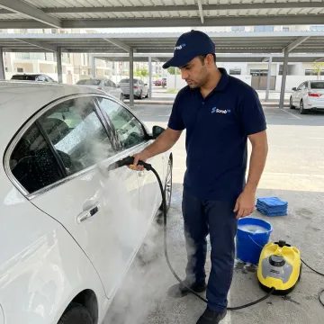 Steam car wash service in Dubai parking area
